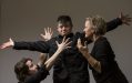 Second Echo Ensemble artists Bella Young, William Webster and Creative Director Kelly Drummond Cawthon. Young and Cawthon, two Caucasian woman, surround Webster, a man with his arms outstretched. Storytelling.