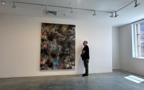 Man looking at abstract painting.