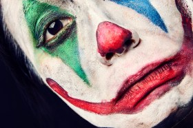 Close detail of a clown's painted face. arts news