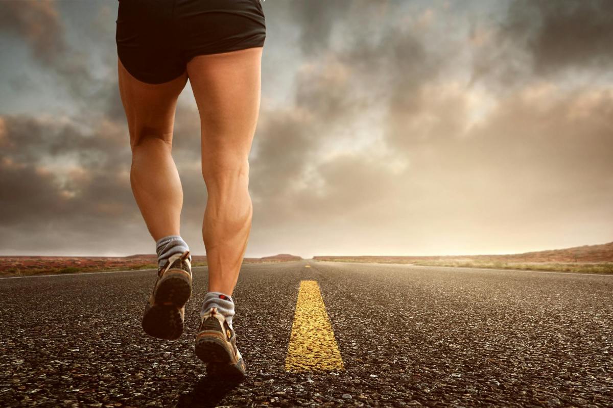 On the Move is ArtsHub's weekly roundup of Australian arts sector appointments. The photo, which is taken from a low angle, shows a joggers feet and legs as they run along a flat stretch of open road.