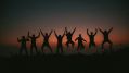 On the Move is ArtsHub's weekly wrap of Australian arts sector appointments and departures. The photo shows six people silhouetted against a sunset; they are all leaping joyously into the air, their arms raised above their heads triumphantly.