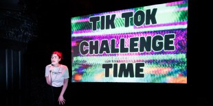 Charlotte Otton: a woman is standing in front of a large screen that says 'Tik Tok Challenge Time'.