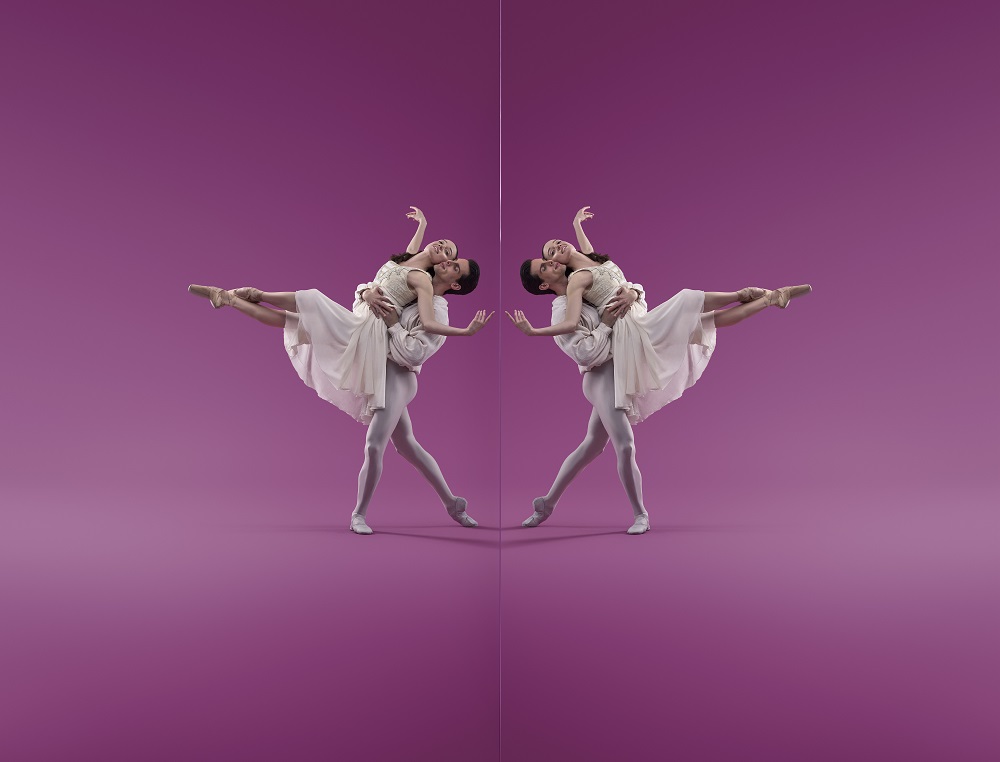 ballet companies: a male-female ballet pas de deux posing in a white tutu costume against a bright pink backdrop. Their pose is mirror imaged on each half of the photo.