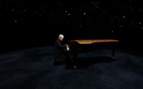 Ryuichi Sakamoto in mixed-reality, ‘KAGAMI’. A virtual image of Sakamoto playing a black grand piano in a limbo or dark virtual space.