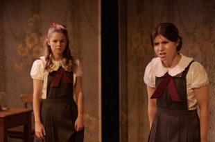 Two young girls in school uniform.