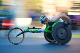 On the Move is ArtsHubs weekly round up of arts sector appointments and resignations from around the country. The photo, taken with a slow shutter speed and manual tracking during the 2017 Chicago Marathon, depicts a man using a racnig wheelchair to compete in the marathon. The background of the photo is blurred, conveying the speed with which the three-wheeled wheelchair is propelled.