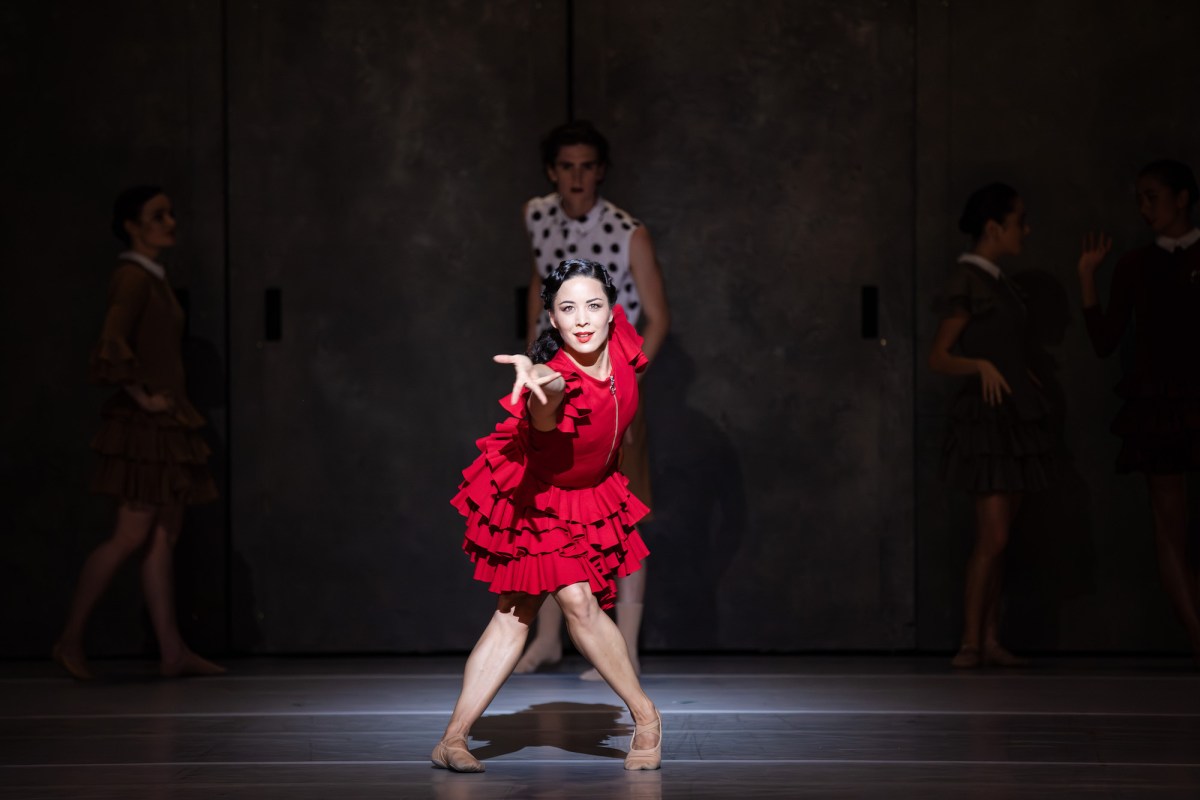 Ballet dancer in red dress performing on stage. Carmen