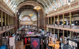 Old architecture exposition building displaying quilt convention.