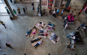 People laying on floor and others looking in industrial arts space. White Bay Power Station