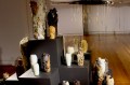 A series of vases on plinths. Some are plain, others are blistered.