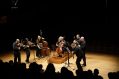 A group of musicians playing string instruments.